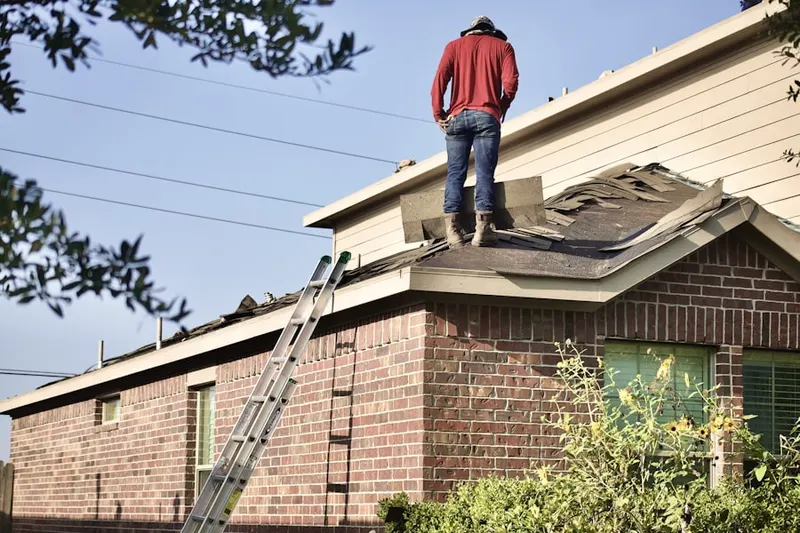 Professional roofer working on a residential roof in Peppermill Village